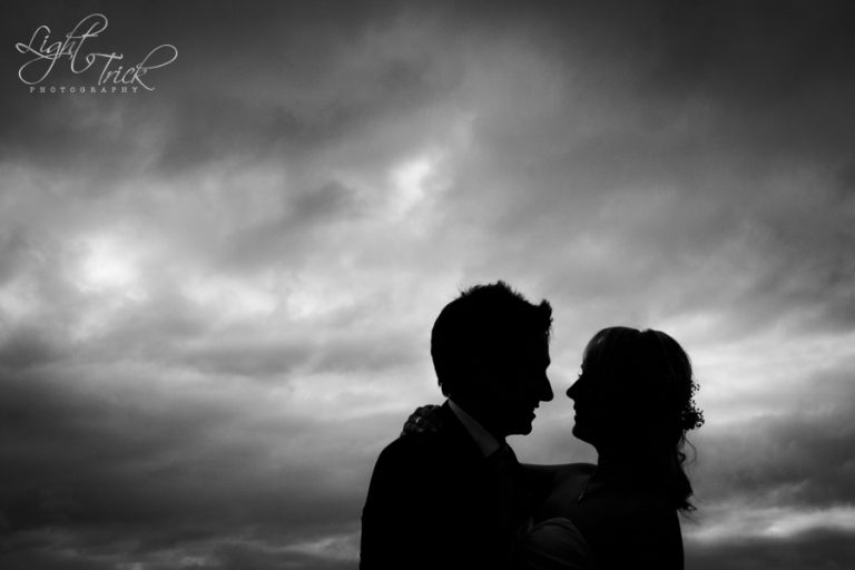 black and white wedding couple silhouette - dramatic sky